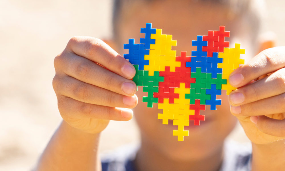child holding heart puzzle