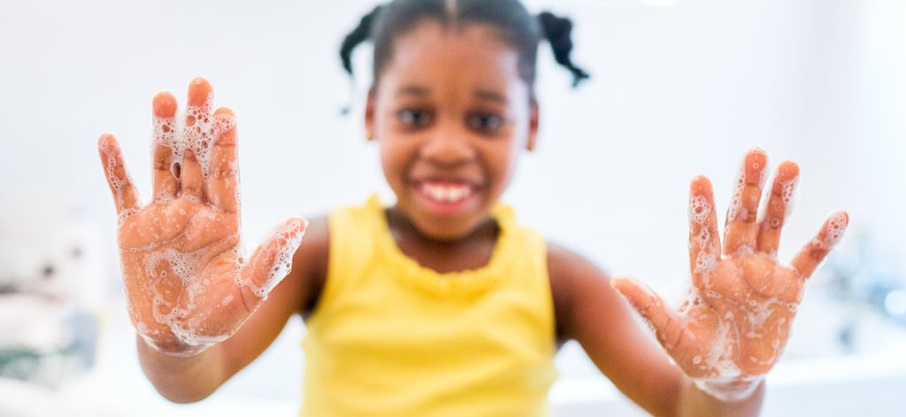 Young black girl with soapy hands