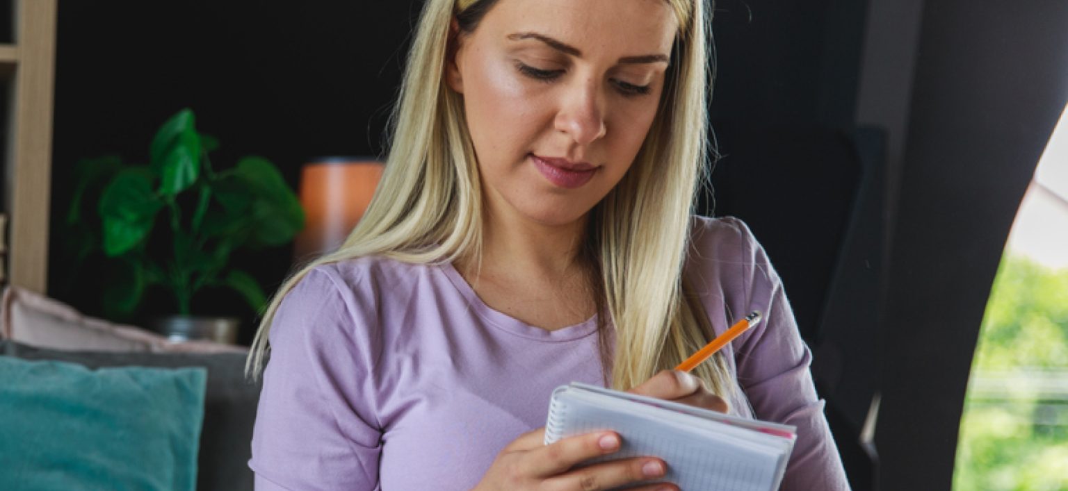 Pregnant mother writing a list