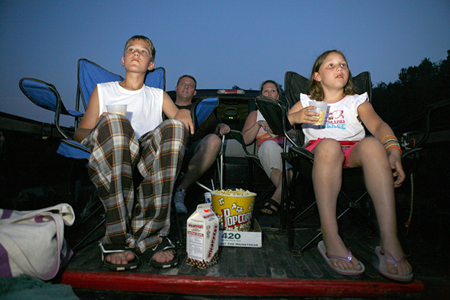 Family watching movie in truck bed at Finger Lakes Drive-In