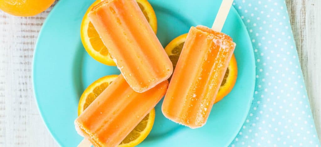 Orange Creamsicle Popsicles on a plate.