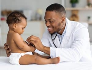 Baby at well visit with doctor.