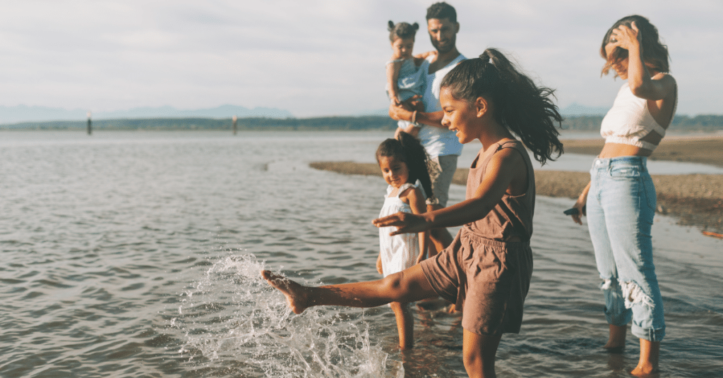 family standing on beach
